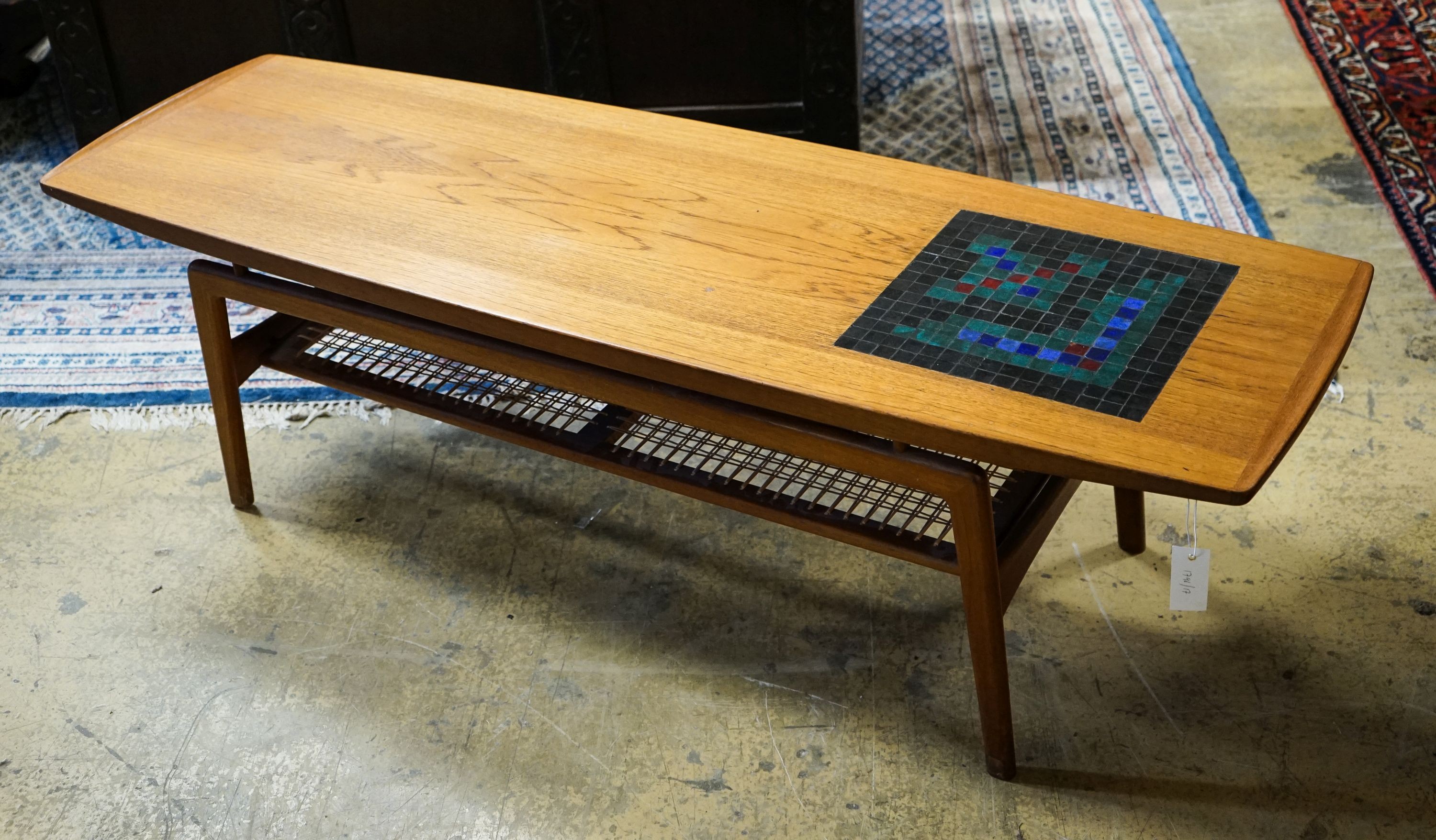 Arne Hovmand Olsen for Mogens Kold. A rectangular tiled top teak coffee table with caned undertier, length 148cm, depth 48cm, height 42cm